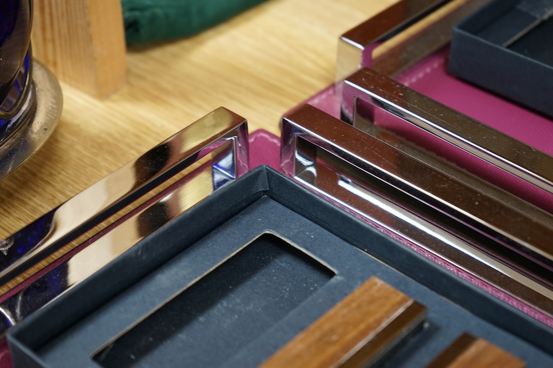 David Linley, two chrome and leather square trays together with two incomplete sets of menu holders. Condition - trays good, rests tarnished in places & would benefit from a clean